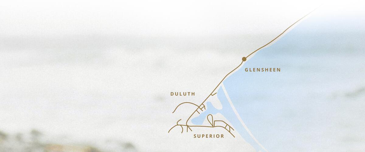 Blurred background of lakeshore with a general map of where Glensheen is in comparison to Duluth and Superior