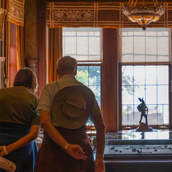 A couple looking at artifacts in the Library at Glensheen.