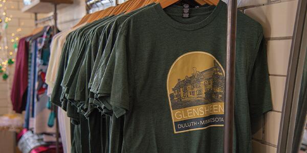 T-shirts hanging on a rack in the Museum Shop.