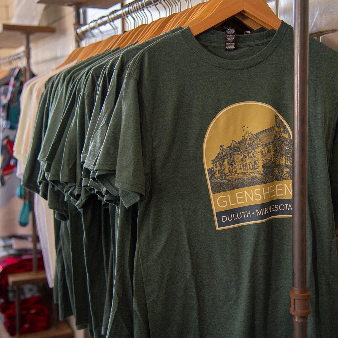 T-shirts hanging on a rack in the Museum Shop.