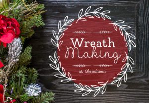 A red circle with the text Wreath Making at Glensheen in it with a white wreath on the outside and some green and red garland sitting on a wooden table.